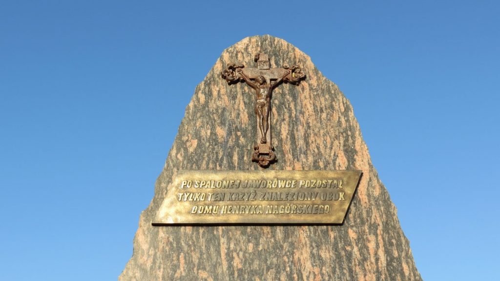 Kamień z tablicą upamiętniającą tragiczne wydarzenia w Jaworówce. Na kamieniu zawieszony jest ocalały krzyż.